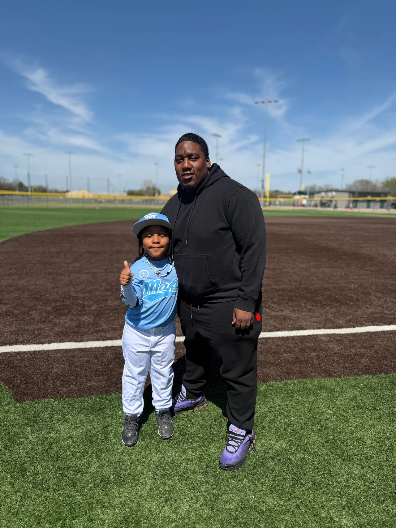 Coach Kev and his son King on the field